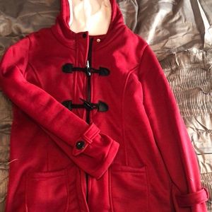 Red sweatshirt jacket with zipper and black buttons.